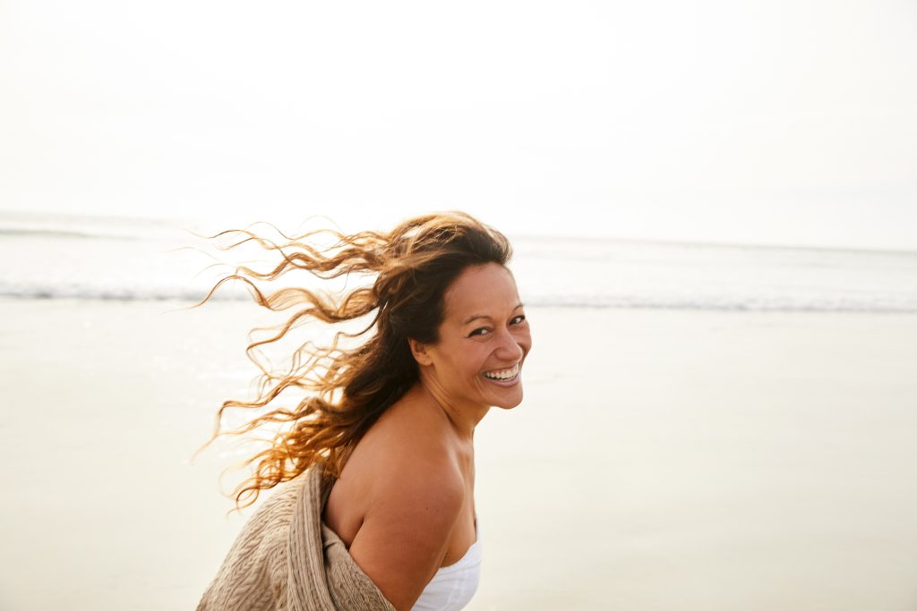 Laughing mature woman on a beach