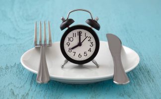 Lifestyle image alarm clock with fork and knife